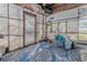 Enclosed porch with blue rug, open lattice work, and assorted storage containers at 151 Holland Rd, Ormond Beach, FL 32176