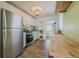 Modern kitchen with stainless steel refrigerator, white cabinets, and wood countertops at 151 Holland Rd, Ormond Beach, FL 32176