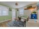 Cozy living room featuring wood floors, a patterned rug, and bright green walls at 151 Holland Rd, Ormond Beach, FL 32176