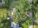 This aerial image shows the home's roof, expansive green yard, and mature shade trees at 2120 Queen Palm Dr, Edgewater, FL 32141