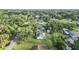 Features an aerial view of a quaint home, lush green yard, and tree-lined neighborhood at 2120 Queen Palm Dr, Edgewater, FL 32141