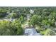 High aerial shot of the property in a neighborhood with mature trees and access to a body of water at 2120 Queen Palm Dr, Edgewater, FL 32141
