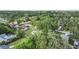Aerial view showing the house nestled in a lush, green neighborhood with mature trees at 2120 Queen Palm Dr, Edgewater, FL 32141
