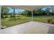 View of the spacious backyard with lush green lawn from the covered patio area at 2120 Queen Palm Dr, Edgewater, FL 32141