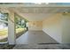 Attached carport featuring a clean, finished floor, house number, and butterfly adornment at 2120 Queen Palm Dr, Edgewater, FL 32141