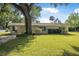 Charming single-story home featuring a well-manicured lawn and mature landscaping at 2120 Queen Palm Dr, Edgewater, FL 32141