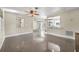 Open concept living room with a ceiling fan and access to the kitchen at 2120 Queen Palm Dr, Edgewater, FL 32141