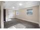 Spacious living room with a tiled floor, a bright white door, and two windows for natural light at 2120 Queen Palm Dr, Edgewater, FL 32141
