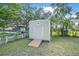 Durable storage shed in backyard with ramp, providing convenient storage for tools and equipment at 2120 Queen Palm Dr, Edgewater, FL 32141