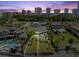 Waterfront home featuring a pool, lush landscaping, and city skyline views at 2924 River Point Dr, Daytona Beach, FL 32118