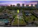 Aerial view of a beautiful home featuring a pool, manicured lawn, and waterfront access with city skyline backdrop at 2924 River Point Dr, Daytona Beach, FL 32118
