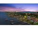 Waterfront home featuring a pool, lush landscaping, and stunning ocean and city views at 2924 River Point Dr, Daytona Beach, FL 32118