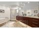 Elegant bathroom featuring double vanity, marble floors, and glass shower enclosure at 2924 River Point Dr, Daytona Beach, FL 32118