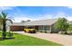 Beautiful home exterior with a stone facade, a well-manicured lawn, and a paved driveway at 2924 River Point Dr, Daytona Beach, FL 32118