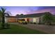 Charming home exterior features a brick driveway, manicured lawn and an attached garage with a classic car parked at 2924 River Point Dr, Daytona Beach, FL 32118