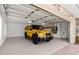 Well-lit garage showcasing a yellow luxury SUV parked inside, highlighting the space and accessibility at 2924 River Point Dr, Daytona Beach, FL 32118
