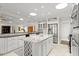 Bright kitchen featuring white cabinetry, stainless steel appliances, and an island with seating at 2924 River Point Dr, Daytona Beach, FL 32118