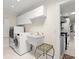 Practical laundry room with modern washer and dryer, utility sink, and ample cabinet space at 2924 River Point Dr, Daytona Beach, FL 32118