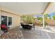 Covered outdoor patio area with a dining set and lounging chairs, creating an inviting outdoor living space at 2924 River Point Dr, Daytona Beach, FL 32118