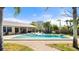 Backyard pool with brick trim and palm trees, offering a tranquil setting for relaxation and recreation at 2924 River Point Dr, Daytona Beach, FL 32118