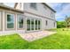 Backyard of home featuring sliding glass doors and brick patio at 32 Ocean Breeze Cir, Ormond Beach, FL 32176