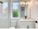 Bright bathroom featuring tiled shower, modern fixtures, and a window providing natural light at 32 Ocean Breeze Cir, Ormond Beach, FL 32176