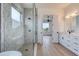 Modern bathroom featuring a glass shower, double sink vanity, and wood-look flooring at 32 Ocean Breeze Cir, Ormond Beach, FL 32176