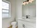 Bathroom featuring a window, white vanity, black hardware, and neutral walls at 32 Ocean Breeze Cir, Ormond Beach, FL 32176