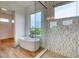 Bright bathroom featuring a free-standing tub, walk-in shower, and wood-look floors at 32 Ocean Breeze Cir, Ormond Beach, FL 32176