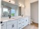 Elegant bathroom with double sinks, white cabinetry, and modern fixtures at 32 Ocean Breeze Cir, Ormond Beach, FL 32176