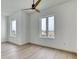 Light and bright bedroom with wood-look floors, a ceiling fan, and two windows at 32 Ocean Breeze Cir, Ormond Beach, FL 32176