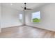 Spacious bedroom with hardwood floors, large windows, and a modern ceiling fan at 32 Ocean Breeze Cir, Ormond Beach, FL 32176