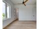 Bedroom with light wood floors, a ceiling fan, and a doorway to a walk-in closet at 32 Ocean Breeze Cir, Ormond Beach, FL 32176