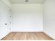 Minimalist bedroom features neutral walls, wood-look tile flooring, and a closet at 32 Ocean Breeze Cir, Ormond Beach, FL 32176