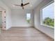 Bright bedroom with wood floors, ceiling fan, and ample natural light at 32 Ocean Breeze Cir, Ormond Beach, FL 32176