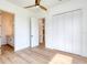 Bright bedroom featuring wood-look laminate floors and ensuite access to a bathroom at 32 Ocean Breeze Cir, Ormond Beach, FL 32176