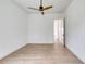 A clean, minimalist bedroom design, with a modern ceiling fan and wood-look laminate flooring at 32 Ocean Breeze Cir, Ormond Beach, FL 32176