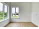 Sunlit bedroom offers wood-look tile flooring and ample natural light at 32 Ocean Breeze Cir, Ormond Beach, FL 32176