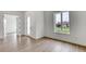 Bright bedroom with wood-look tile flooring and large windows for natural light at 32 Ocean Breeze Cir, Ormond Beach, FL 32176