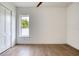 Bright bedroom featuring a window and closet, showcasing modern design and wood-look laminate floors at 32 Ocean Breeze Cir, Ormond Beach, FL 32176