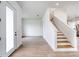 Open-concept foyer features wood-look tile floors and staircase at 32 Ocean Breeze Cir, Ormond Beach, FL 32176
