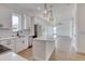 Bright kitchen features white cabinetry, stainless appliances, subway tile backsplash, and island with marble countertop at 32 Ocean Breeze Cir, Ormond Beach, FL 32176