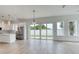 Bright living room features wood-look floors, backyard access, and stainless steel appliances at 32 Ocean Breeze Cir, Ormond Beach, FL 32176