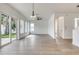 Bright living room featuring wood-look floors with stairs and a bathroom nearby at 32 Ocean Breeze Cir, Ormond Beach, FL 32176