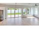 Bright living room features wood-look floors, backyard access, and plenty of natural light at 32 Ocean Breeze Cir, Ormond Beach, FL 32176