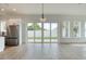 Bright living room with backyard access, wood-look floors, and stainless steel appliances at 32 Ocean Breeze Cir, Ormond Beach, FL 32176