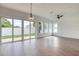 Bright living room features wood-look floors, backyard access, and a ceiling fan at 32 Ocean Breeze Cir, Ormond Beach, FL 32176