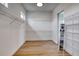 Spacious walk-in closet with built-in shelving and wood-look flooring at 32 Ocean Breeze Cir, Ormond Beach, FL 32176