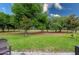 Expansive backyard with lush green grass, mature trees, and an outdoor seating area at 3205 Bailey Ann Dr, Ormond Beach, FL 32174