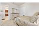 Well-lit bedroom featuring a decorative dresser, closet, and a comfortable bed, creating a relaxing retreat at 3205 Bailey Ann Dr, Ormond Beach, FL 32174